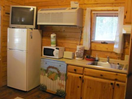 Kitchen complete with pots and pans, dishes and silverware.